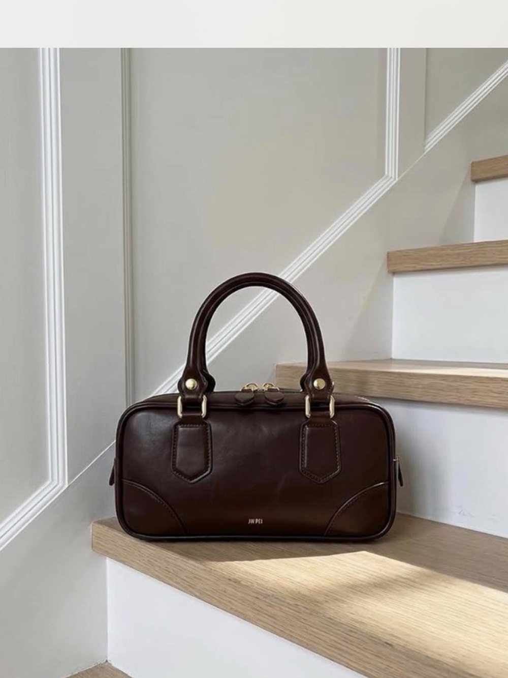 JW PEI classic brown leather top handle handbag with gold hardware.